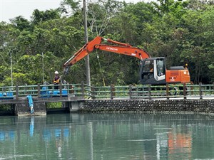 Large machinery opens drainage gates